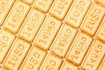 Cookies with the euro and US dollar currency symbols located diagonally , selective focus, background