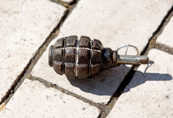 A trap of wire and grenade lies on the asphalt