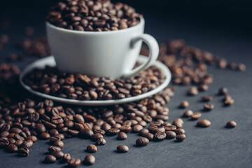 white cup with coffee beans on gray background Arabica variety