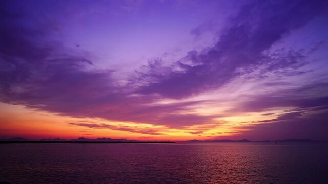 Time-lapse of seascape at sunrise, dramatic sky and colorful clouds