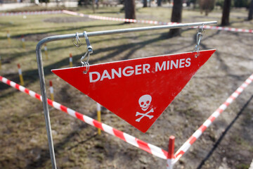 Sign "Danger mines" in a park