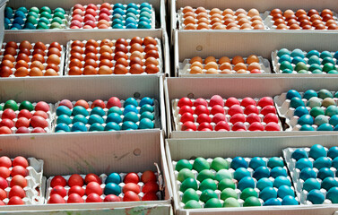 Multicolored Easter eggs in boxes, chicken eggs