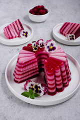 Puding buah naga, Layered pudding made from dragon fruit and milk garnish with edible flowers viola pansy