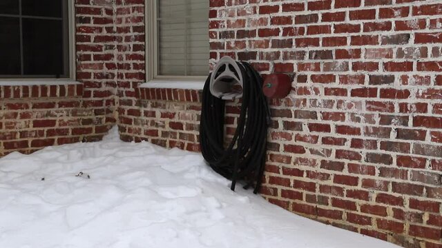 Faucet cover installed on water faucet to protect it from freezing