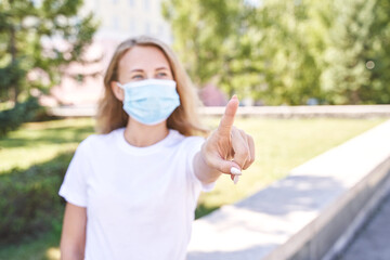 Young woman wearing protective mask outdoors. Medicine equipment. Pandemic safety concept. White...