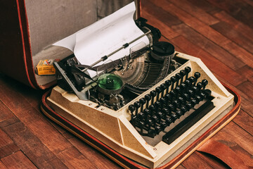 Fototapeta na wymiar retro typewriter on wooden background and paper decoration texture