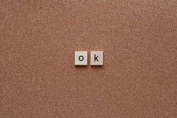 ok wooden letters on cork board