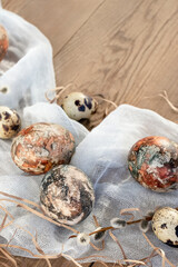Easter composition - Easter eggs painted with natural dyes on a wooden table, copyspace