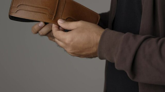 Close up male hand open the empty wallet.There is no money in wallet. Financial business concept.
