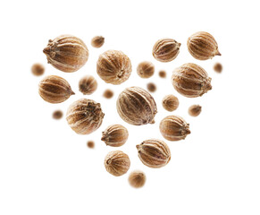 Coriander seeds in the shape of a heart on a white background