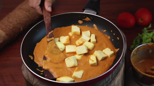 Paneer butter masala , Paneer tikka masala curry Delhi Mumbai North Indian vegetarian side dish  Cooking butter paneer made using cottage cheese, Indian spices 4K slow motion video, footage Kerala, 