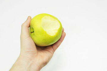 Green apple in hand. Eat healthy fruits.
