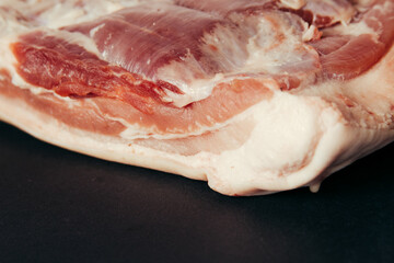 A piece of raw meat on a black background