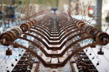 Symmetrical close up an old and rusty loom in and old and abandoned Italian textile factory