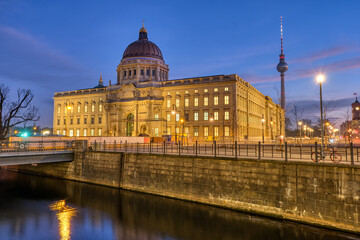 Fototapeta na wymiar The imposing rebuilt Berlin City Palace with the Television Tower at dawn