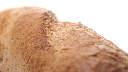Extreme close up macro footage of beautiful loaf of white bread, ready for breakfast on white background. Fresh bread, just from the oven on turntable isolated.