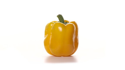 Beautiful footage of yellow pepper on white background. The pepper revolves or rotate around itself.