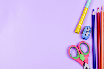 School supplies on a colored background. Childrens still life on the topic of school, study, office work. Flat lay