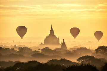 Silhouette of Tourist Balloon flying over the Pagoda in the Morning at Bagan, Myanmar 