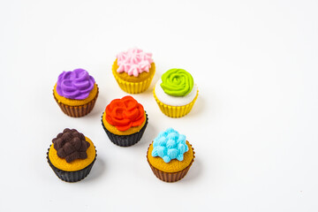 View of miniature toy kitchenware and foods on white background. Image with selective focus and flat lay.