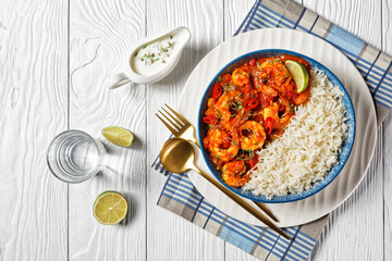 Tomato prawn curry with rice and yogurt, top view