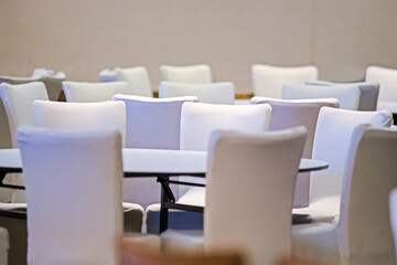 White Empty Chairs Standing Around Tables in The Empty Room.