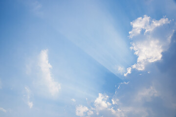 Naklejka na ściany i meble Blue sky and clouds with crepuscular rays