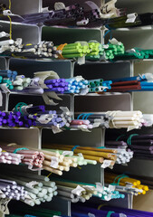 Bright colored glass sticks in a glassblowing workshop. Close-up background.