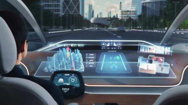 Futuristic Concept: Stylish Businessman Setting Location on an Interactive 3D Navigation App on an Augmented Reality Dashboard while Sitting in an Autonomous Self-Driving Zero-Emissions Electric Car. 