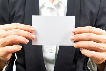 Business woman holding blank card on white background
