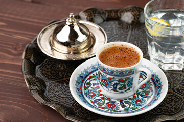 Cup of coffee in oriental style on metal tray