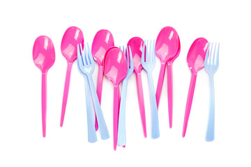 Plastic spoons and forks on white background