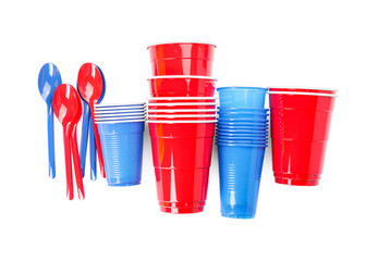 Plastic spoons and cups on white background