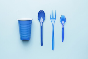 Plastic tableware on color background