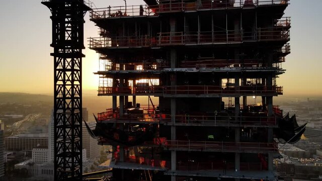 Aerial shot of a new high-rise building under construction at sunrise