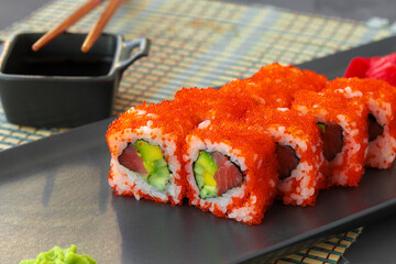 California sushi roll served on black ceramic plate