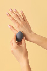 Hands with makeup sponge on color background
