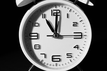 Alarm clock on black background, closeup