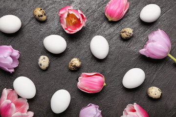 Composition with Easter eggs and spring flowers on dark background