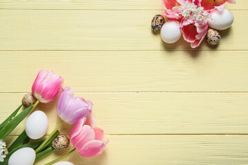 Composition with Easter eggs and spring flowers on color wooden background