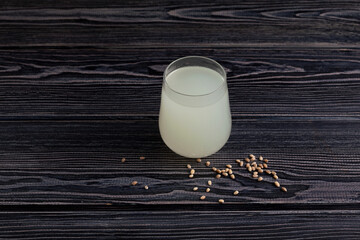 Rejuvelac or home made kvass on dark wooden background. Healthy fermented drink. Natural probiotic...