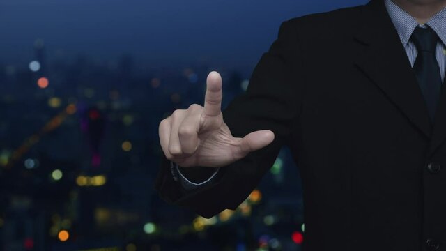 Businessman pressing map pin point location button over blur colorful night light modern city tower and skyscraper, Map pointer navigation online concept