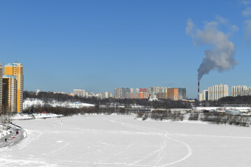 Fototapeta premium Snow-covered Moskva River and Mitino District. Moscow, Russia