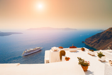 Beautiful sunset at Santorini island, Greece. White architecture on the rocks with sea view. Famous travel destination