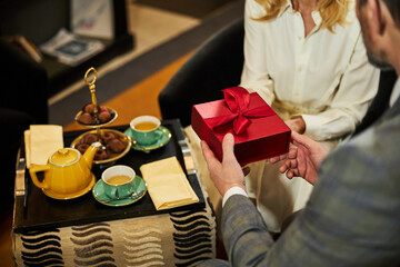 Fragment photo of gentleman giving gift to his date