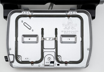 electric grill with open lid. the panels were removed. Made of stainless steel, special non-stick...