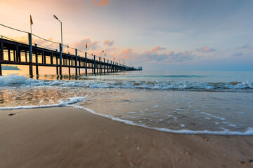 Fototapeta premium beach, sea, pier, sunset, ocean, water, sky, sand, landscape, coast, nature, summer, travel, clouds, sun, bridge, vacation, jetty, sunrise, island, blue, shore, holiday, waves, wave