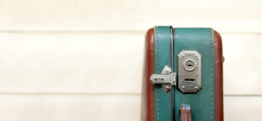 old shabby retro suitcase with an open lock that has begun to rust. waiting for travel