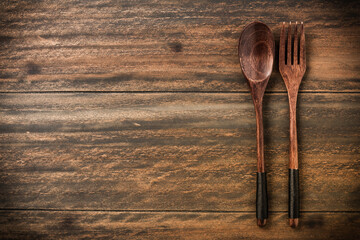 Wooden spoon and fork on rustic wooden table