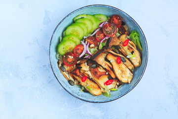 Salad bowl with roaster king oyster mushrooms, tomato, cucumber and red onion